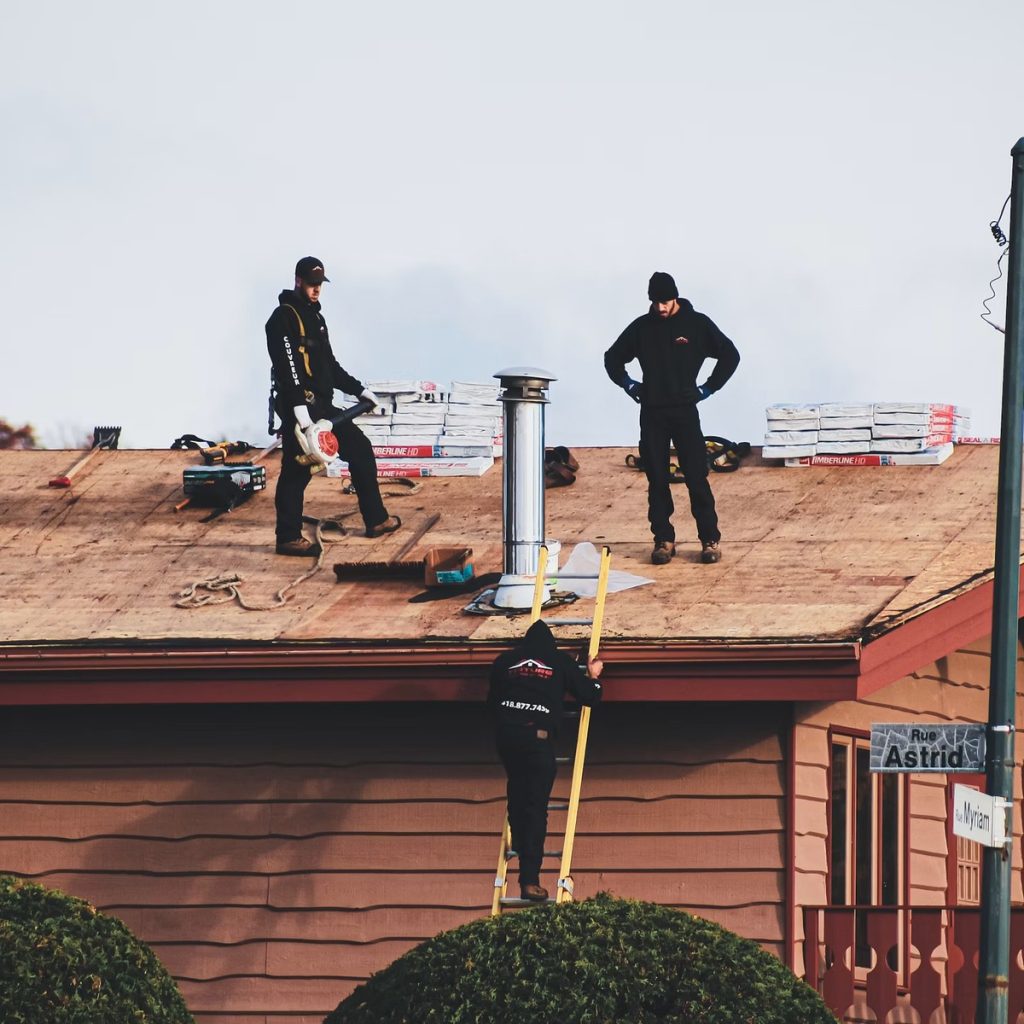 Roofing contractors preparing a residential roof for shingle installation for roofing services near me