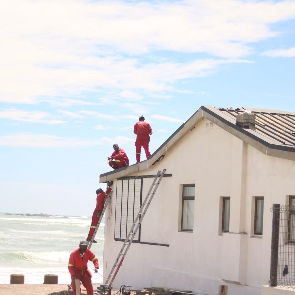 Roofing contractors working on a residential roof in Houston, TX