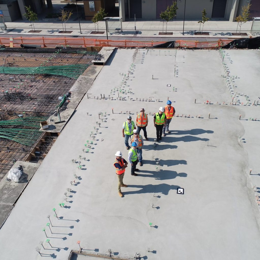 Commercial roofing crew inspecting a large flat roof for roofing contractor services near me