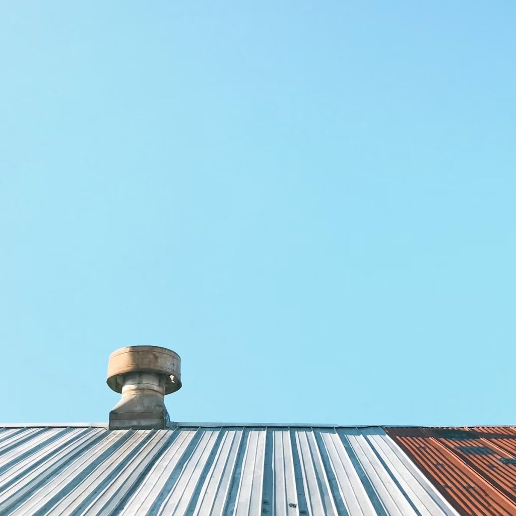 Metal roofing system with rooftop ventilation for roofing contractor services near me