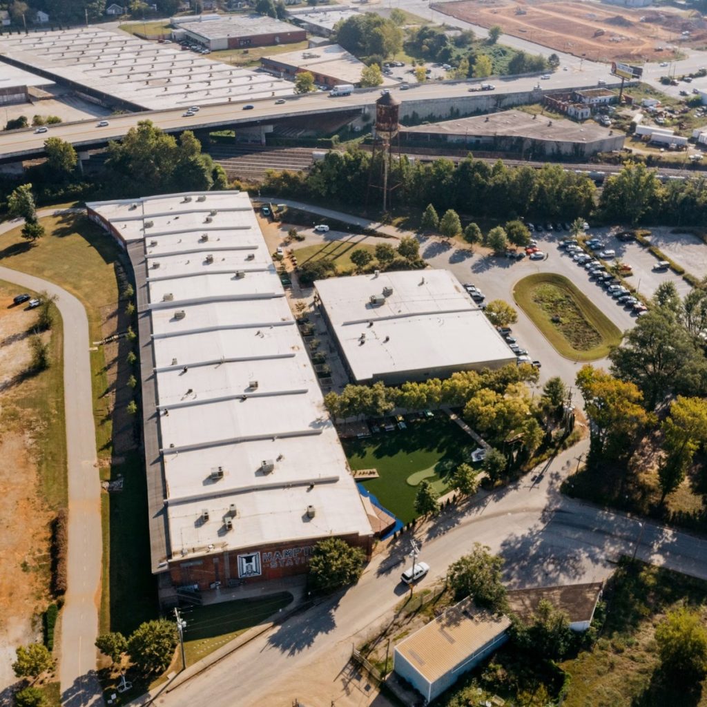 Aerial view of large commercial flat roofing systems for roofing contractor services near me