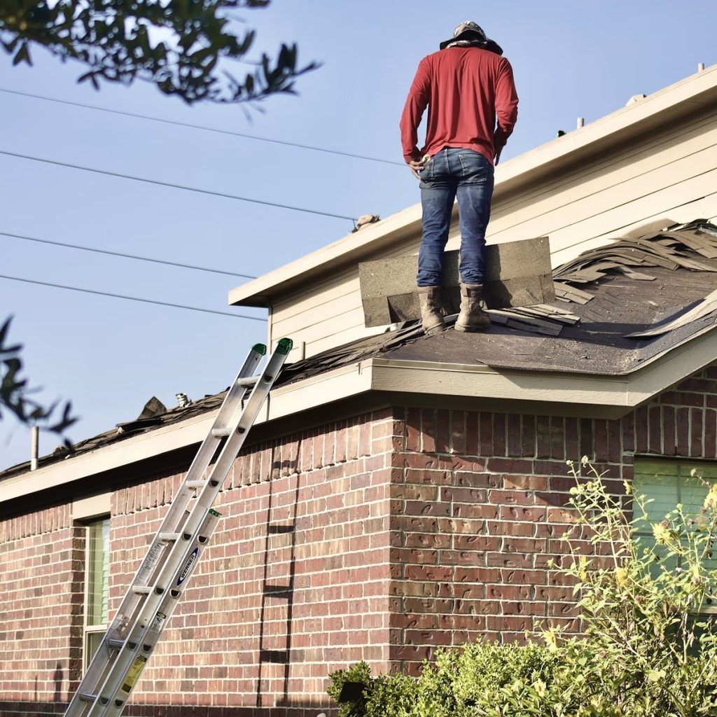 Roofing contractor working on a residential shingle roof replacement in Crosby, TX