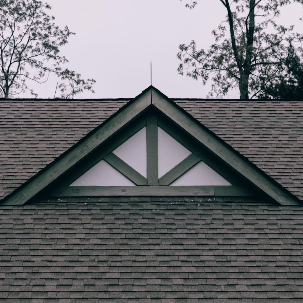 Residential asphalt shingle roof with a prominent gable for roofing services near me